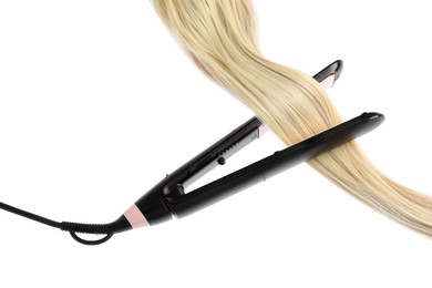 Photo of Straightener with blonde hair lock isolated on white