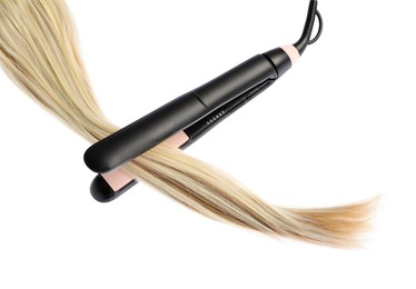Photo of Straightener with blonde hair lock isolated on white