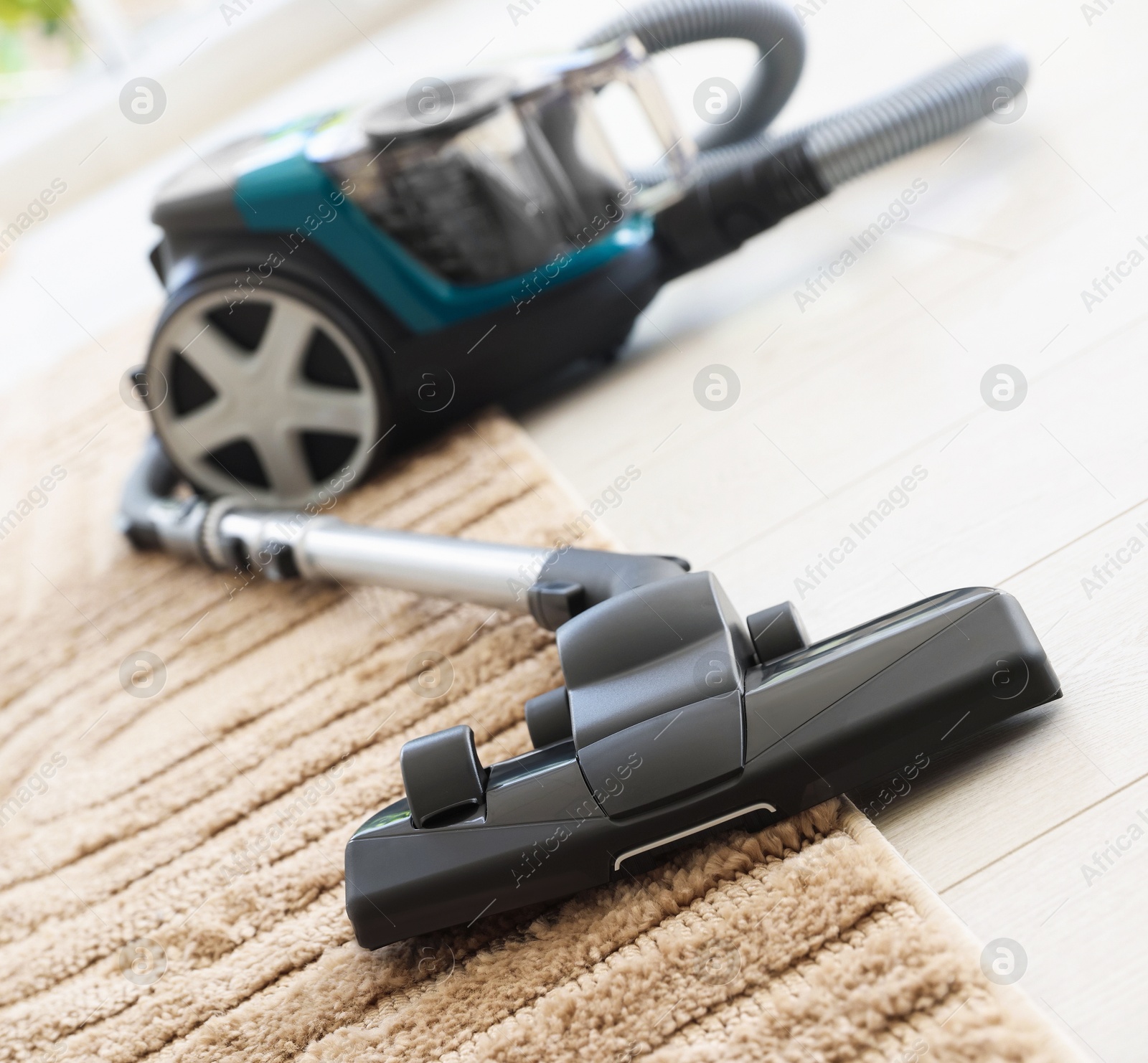 One vacuum cleaner on floor indoors, closeup Photo of One vacuum cleaner on floor indoors, closeup