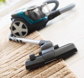 Photo of One vacuum cleaner on floor indoors, closeup