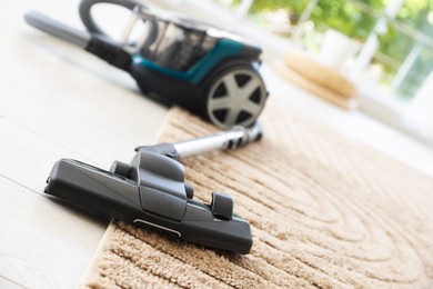 Photo of One vacuum cleaner on floor indoors, closeup