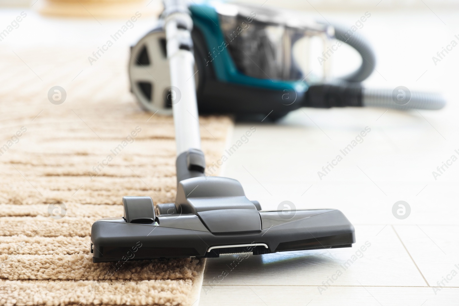 One vacuum cleaner on floor indoors, closeup Photo of One vacuum cleaner on floor indoors, closeup