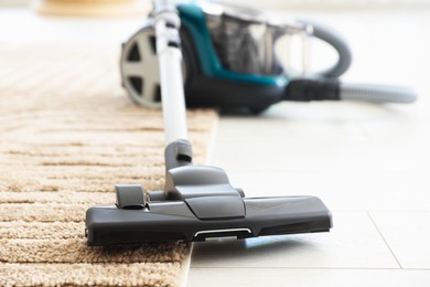 Photo of One vacuum cleaner on floor indoors, closeup