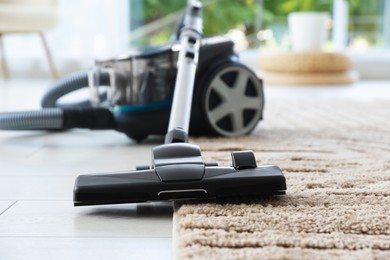 Photo of One vacuum cleaner on floor indoors, closeup