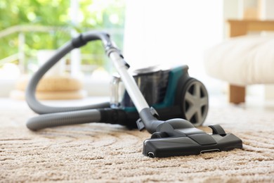 Photo of One vacuum cleaner on floor indoors. Household appliance