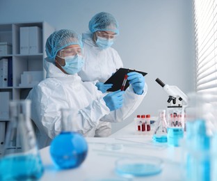 Photo of Medical analysis. Scientists working with blood sample in laboratory