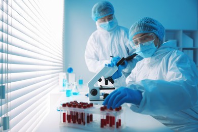 Photo of Medical analysis. Two scientists working with sample in laboratory