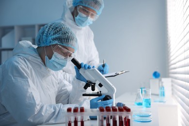 Photo of Medical analysis. Two scientists working with sample in laboratory