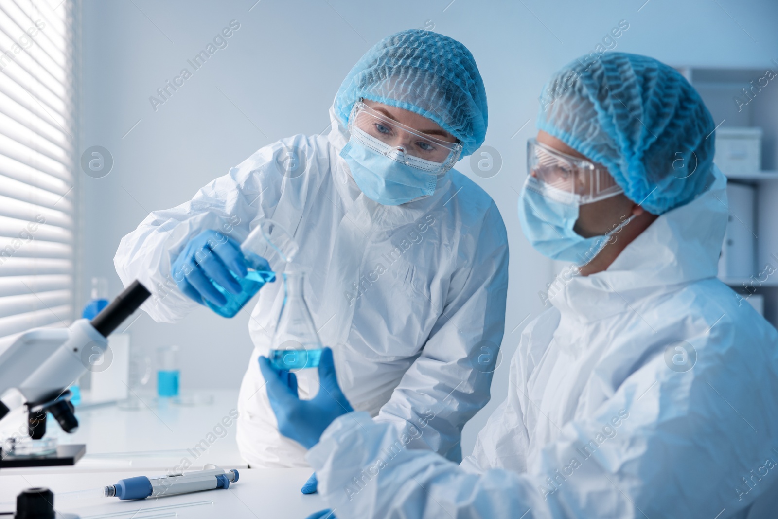 Medical analysis. Two scientists working with sample in laboratory Photo of Medical analysis. Two scientists working with sample in laboratory