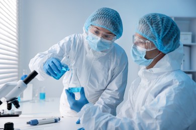 Photo of Medical analysis. Two scientists working with sample in laboratory