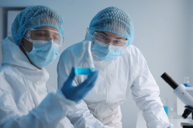 Photo of Medical analysis. Two scientists working with sample in laboratory