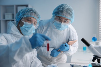 Photo of Medical analysis. Scientists working with blood sample in laboratory