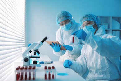 Photo of Medical analysis. Scientists working with blood sample in laboratory