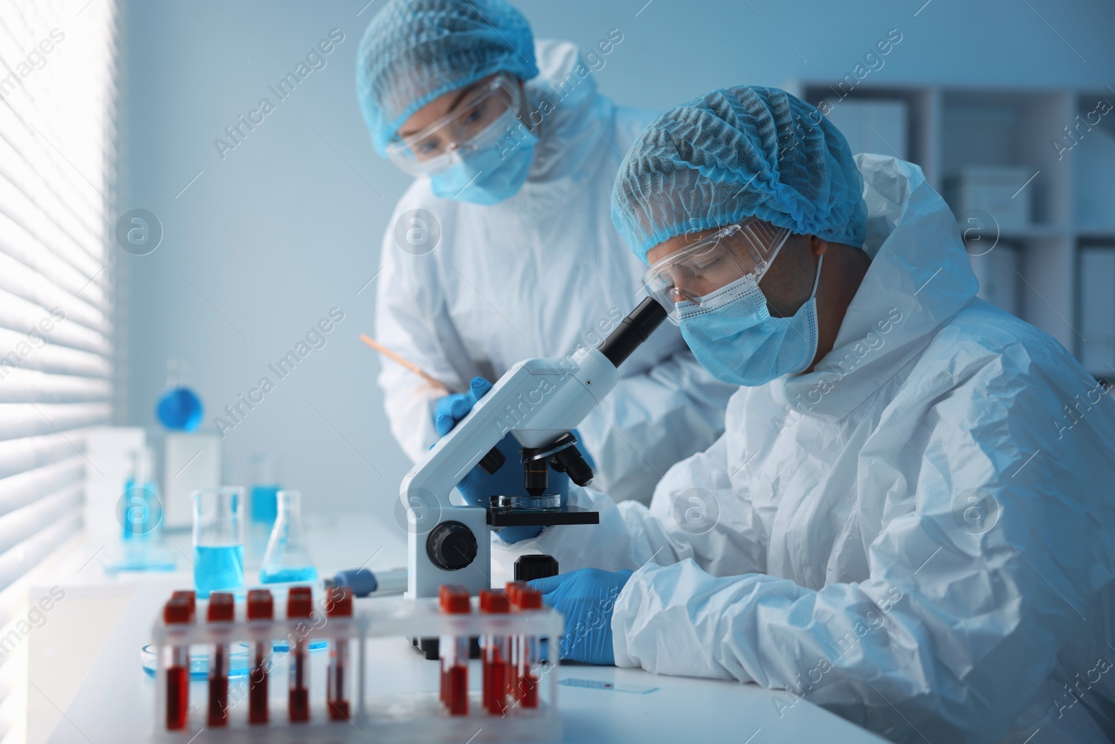 Medical analysis. Scientists working with sample in laboratory Photo of Medical analysis. Scientists working with sample in laboratory