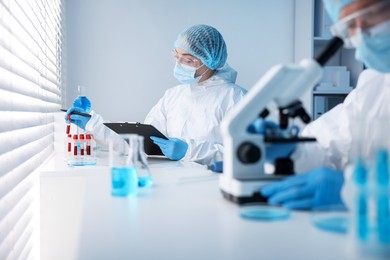 Photo of Medical analysis. Scientists working with samples in laboratory, selective focus
