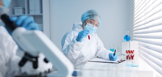 Photo of Medical analysis. Scientist working with blood sample in laboratory, selective focus