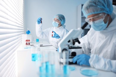 Photo of Medical analysis. Scientists working with samples in laboratory, selective focus