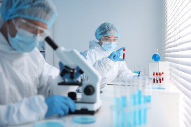 Photo of Medical analysis. Scientists working with samples in laboratory, selective focus