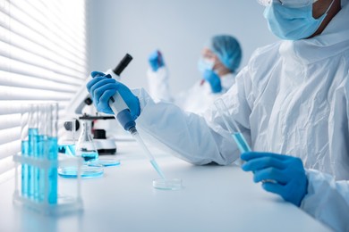 Photo of Medical analysis. Scientists working with samples in laboratory, selective focus