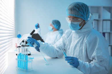 Photo of Medical analysis. Scientists working with samples in laboratory, selective focus