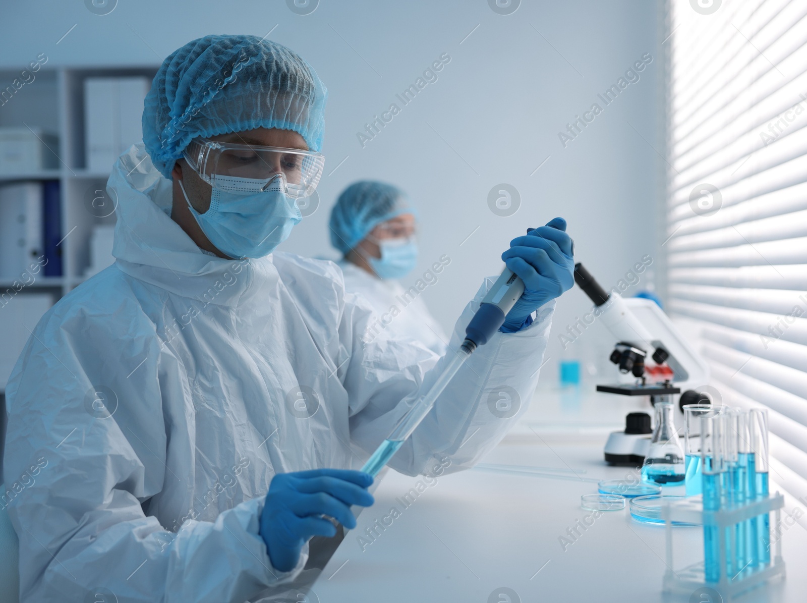 Medical analysis. Scientists working with samples in laboratory, selective focus Photo of Medical analysis. Scientists working with samples in laboratory, selective focus