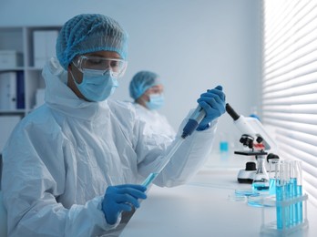 Photo of Medical analysis. Scientists working with samples in laboratory, selective focus
