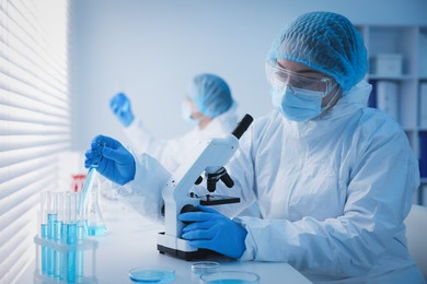 Photo of Medical analysis. Scientists working with samples in laboratory, selective focus