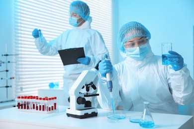 Photo of Medical analysis. Scientists working with samples in laboratory, selective focus