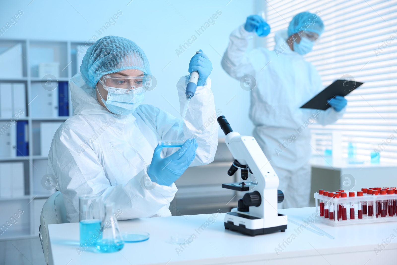 Medical analysis. Scientists working with samples in laboratory, selective focus Photo of Medical analysis. Scientists working with samples in laboratory, selective focus