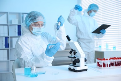 Photo of Medical analysis. Scientists working with samples in laboratory, selective focus