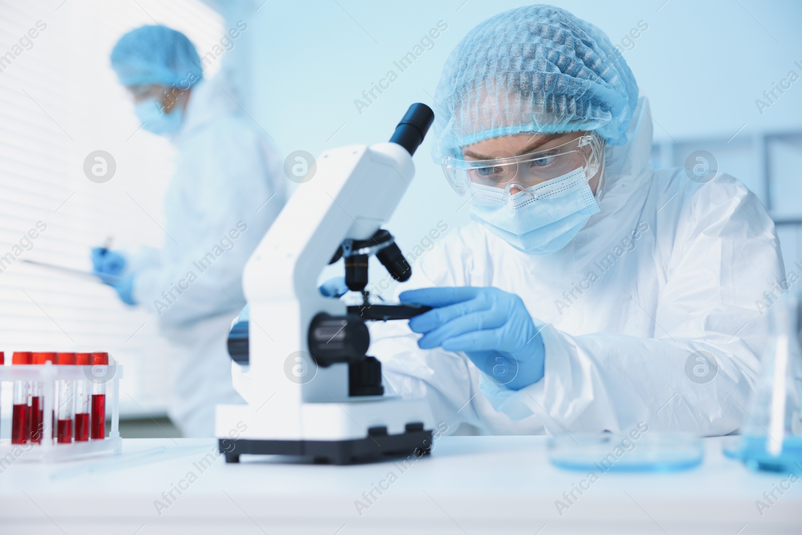 Medical analysis. Scientist working with microscope in laboratory, selective focus Photo of Medical analysis. Scientist working with microscope in laboratory, selective focus
