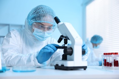 Photo of Medical analysis. Scientist working with microscope in laboratory, selective focus