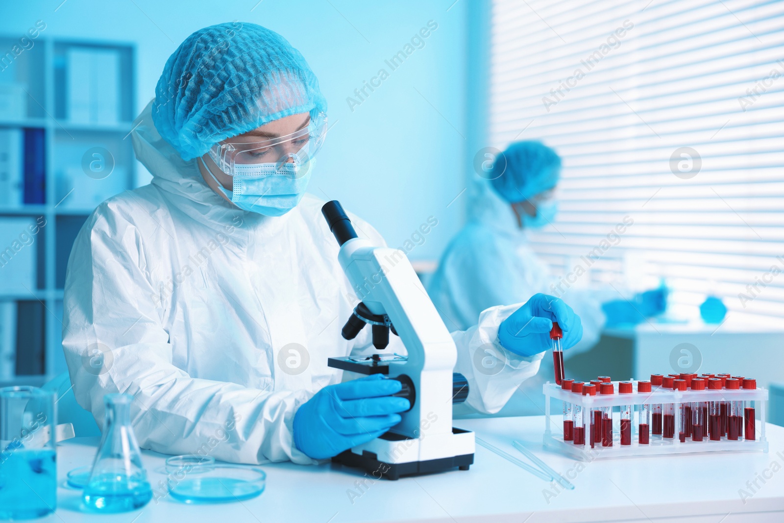 Medical analysis. Scientist working with microscope in laboratory, selective focus Photo of Medical analysis. Scientist working with microscope in laboratory, selective focus