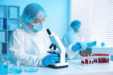 Photo of Medical analysis. Scientist working with microscope in laboratory, selective focus