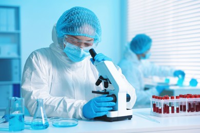 Photo of Medical analysis. Scientist working with microscope in laboratory, selective focus