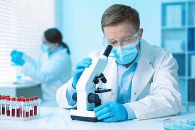 Photo of Medical analysis. Scientist working with microscope in laboratory, selective focus