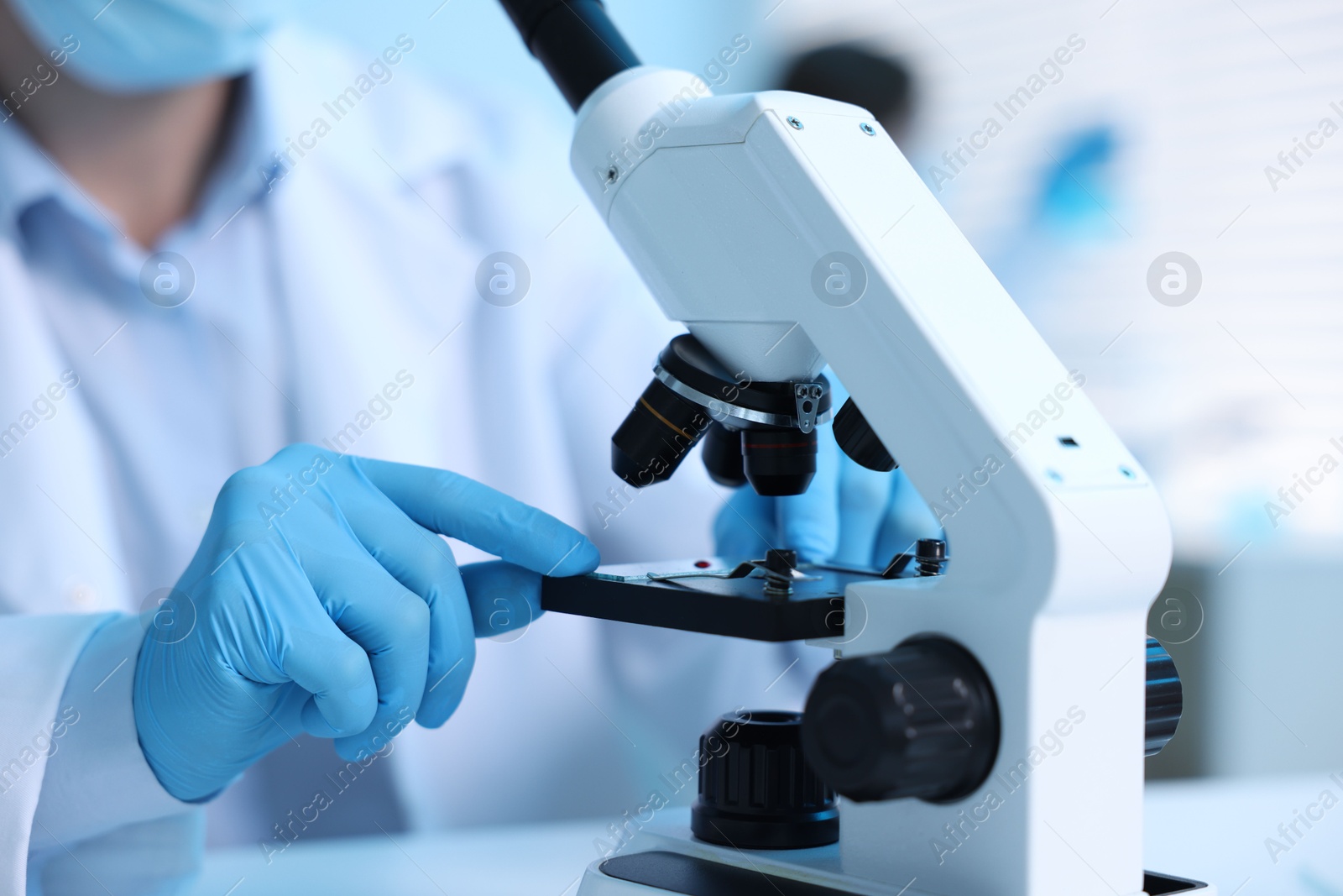 Medical analysis. Scientist working with microscope in laboratory, selective focus Photo of Medical analysis. Scientist working with microscope in laboratory, selective focus