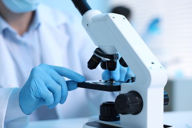 Photo of Medical analysis. Scientist working with microscope in laboratory, selective focus