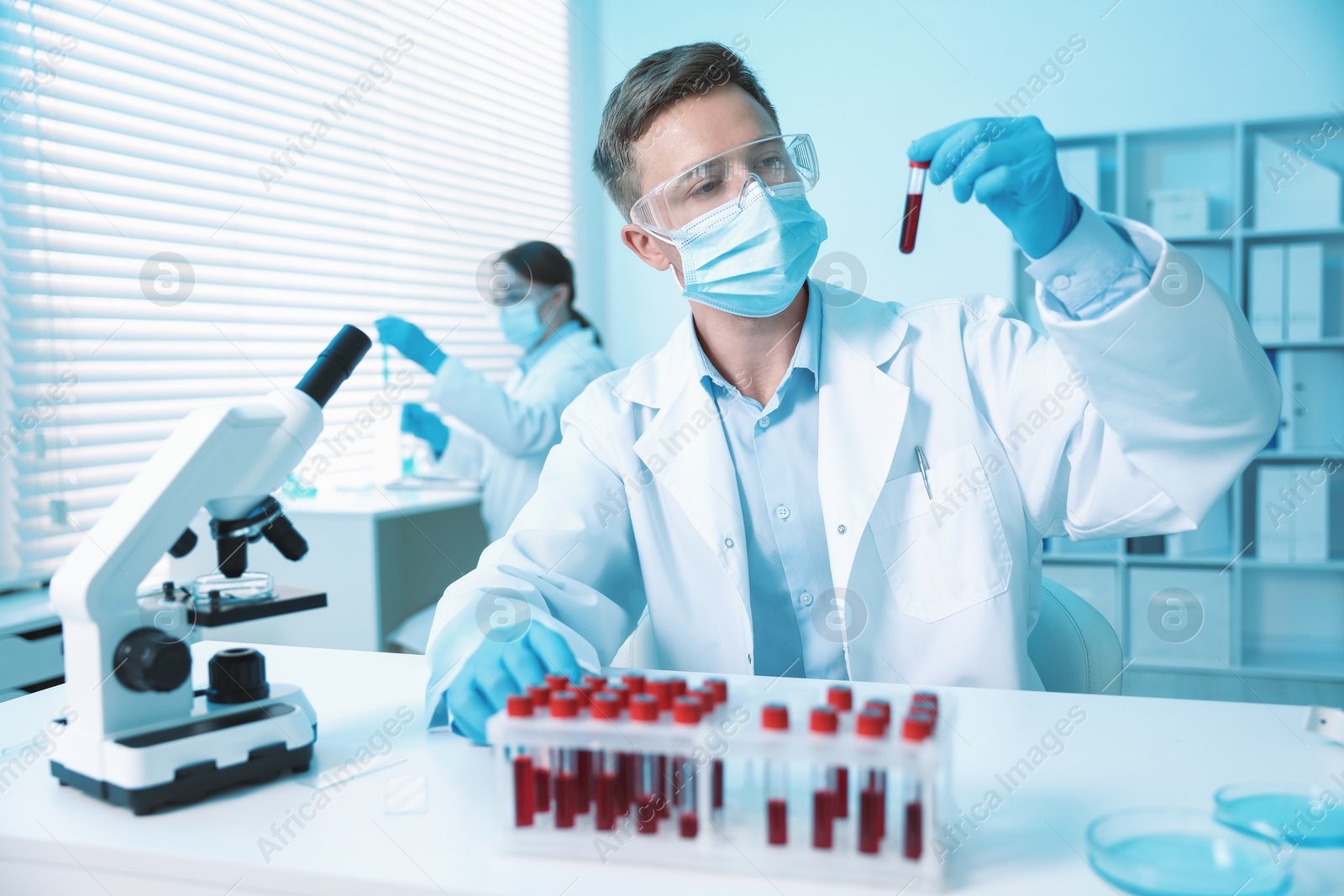 Medical analysis. Scientist working with blood sample in laboratory, selective focus Photo of Medical analysis. Scientist working with blood sample in laboratory, selective focus
