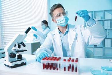 Photo of Medical analysis. Scientist working with blood sample in laboratory, selective focus