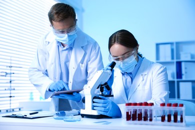Photo of Medical analysis. Scientists working with microscope in laboratory