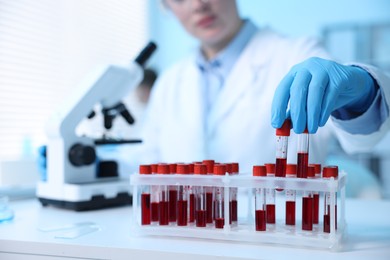 Photo of Medical analysis. Scientist working with blood samples in laboratory, selective focus