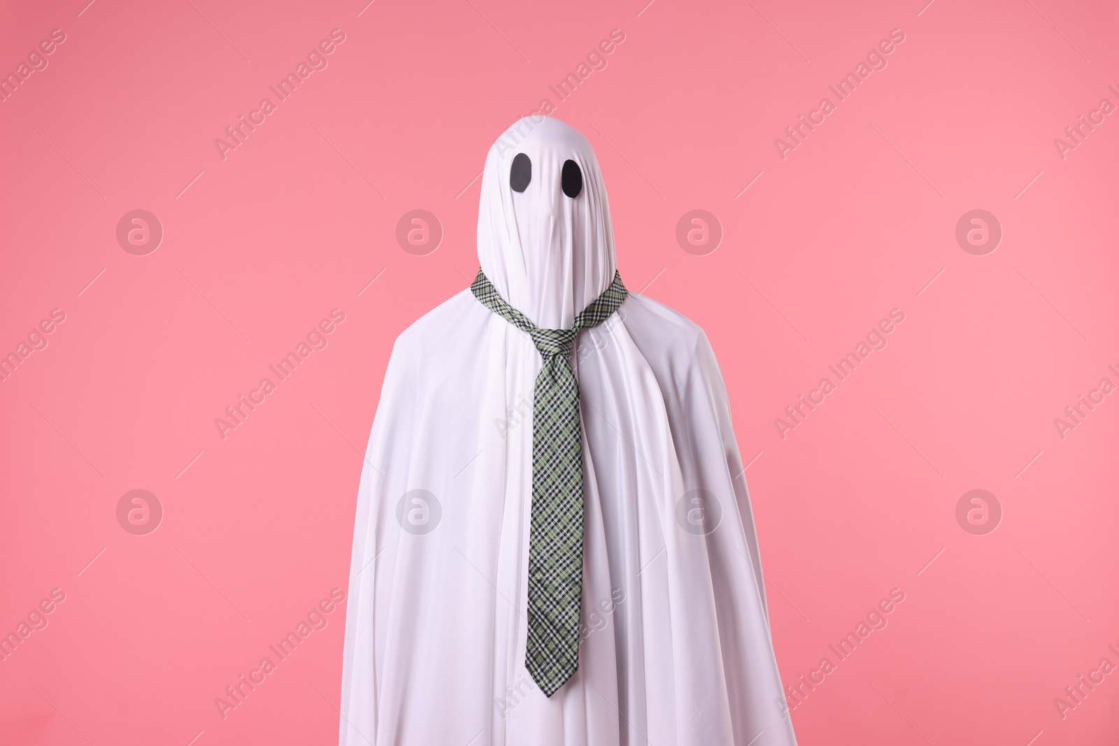 Photo of Man in ghost costume with tie on pink background
