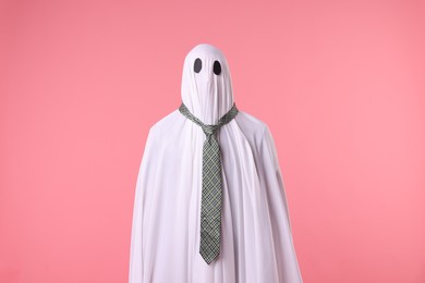 Photo of Man in ghost costume with tie on pink background