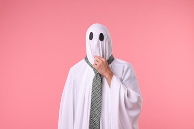 Photo of Man in ghost costume with tie on pink background