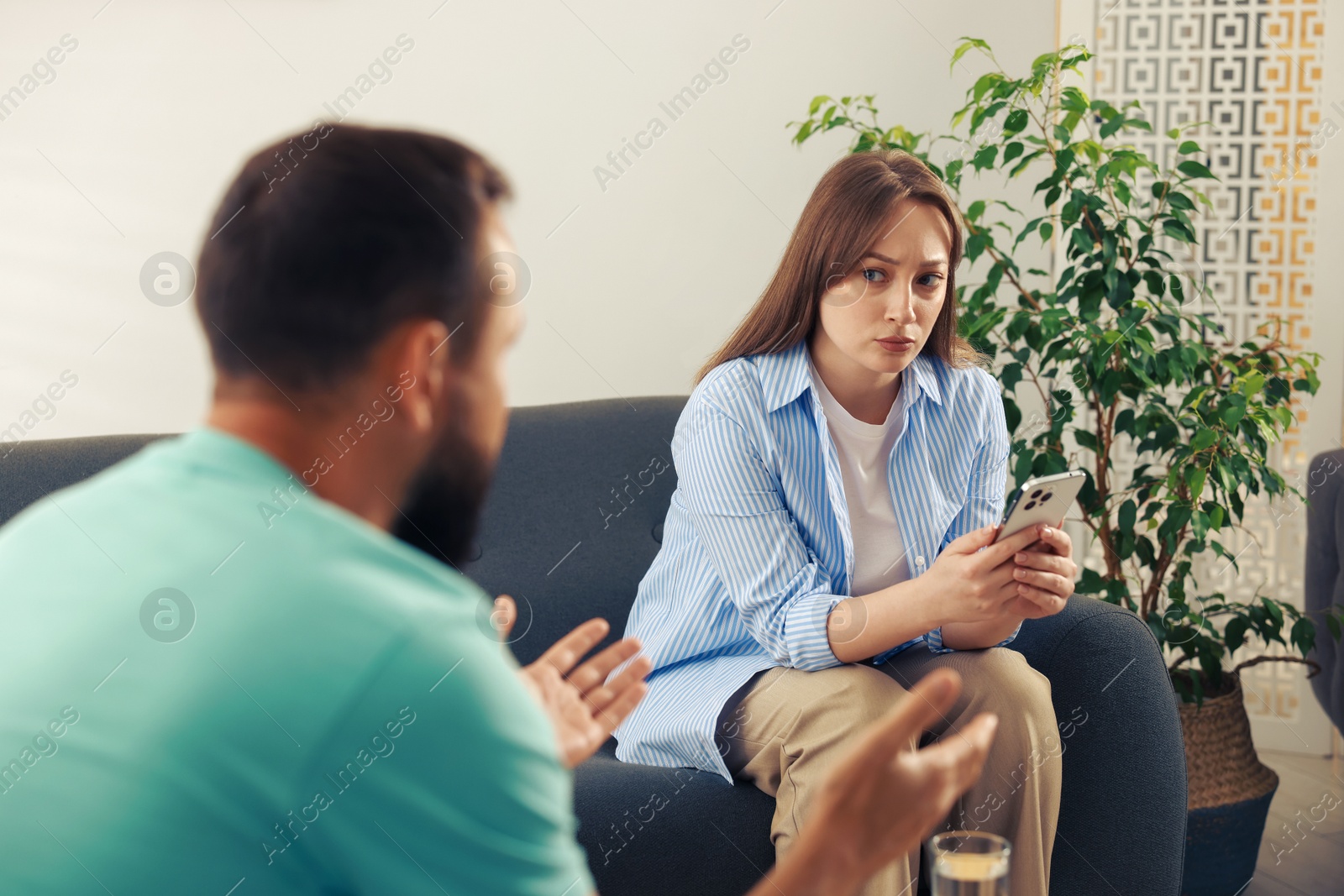 Photo of Betrayal. Husband apologizing to his offended wife at home