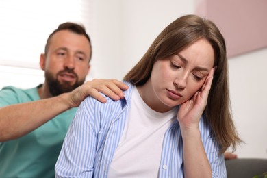 Photo of Betrayal. Husband apologizing to his offended wife at home