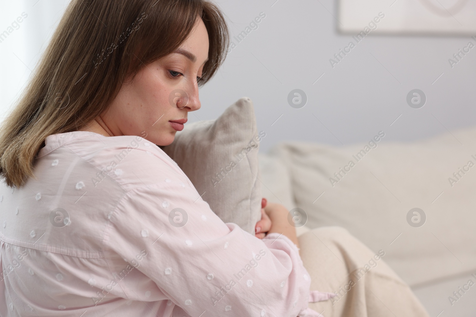 Betrayal. Lonely frustrated woman hugging pillow on sofa at home Photo of Betrayal. Lonely frustrated woman hugging pillow on sofa at home
