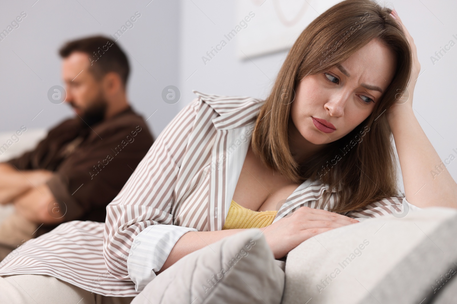 Betrayal. Offended couple ignoring each other at home, selective focus Photo of Betrayal. Offended couple ignoring each other at home, selective focus