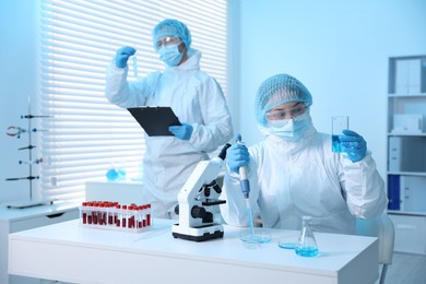 Photo of Medical analysis. Scientists working with samples in laboratory, selective focus